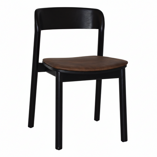Angled view of Matilda black wooden chair with a brown cushion on a white background