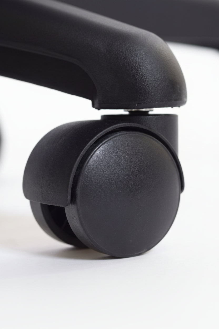 Close-up of a black plastic caster wheel with a matching black protective cover on a white background.