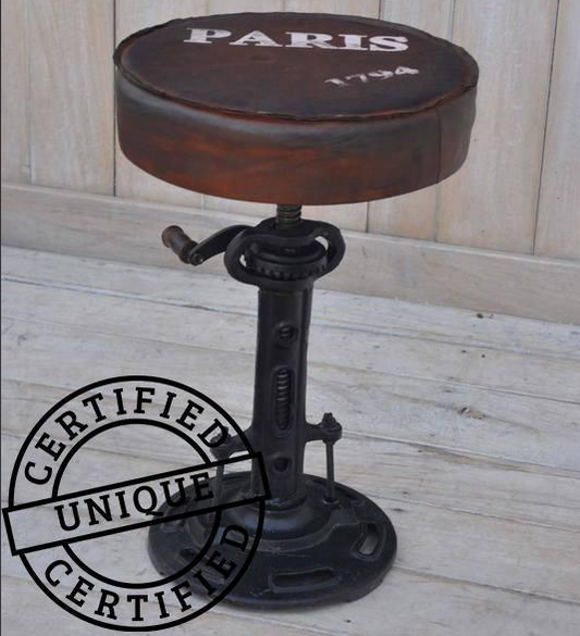 Paris wind up Industrial-style stool with 'PARIS 1794' on the cushion, placed on a wooden floor.