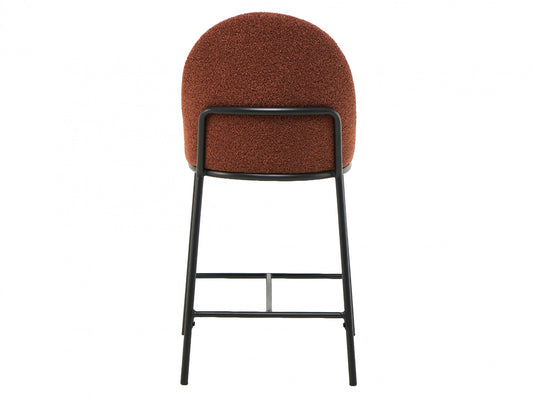 Back of Bar stool with terracotta cushioned seat and black metal frame on a white background