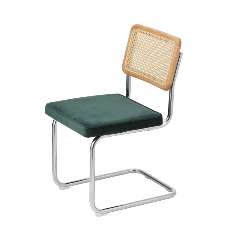 Angled view of Steph chair with chrome frame, wicker backrest, and green cushion on a white background